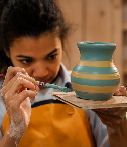 medium shot woman painting pot